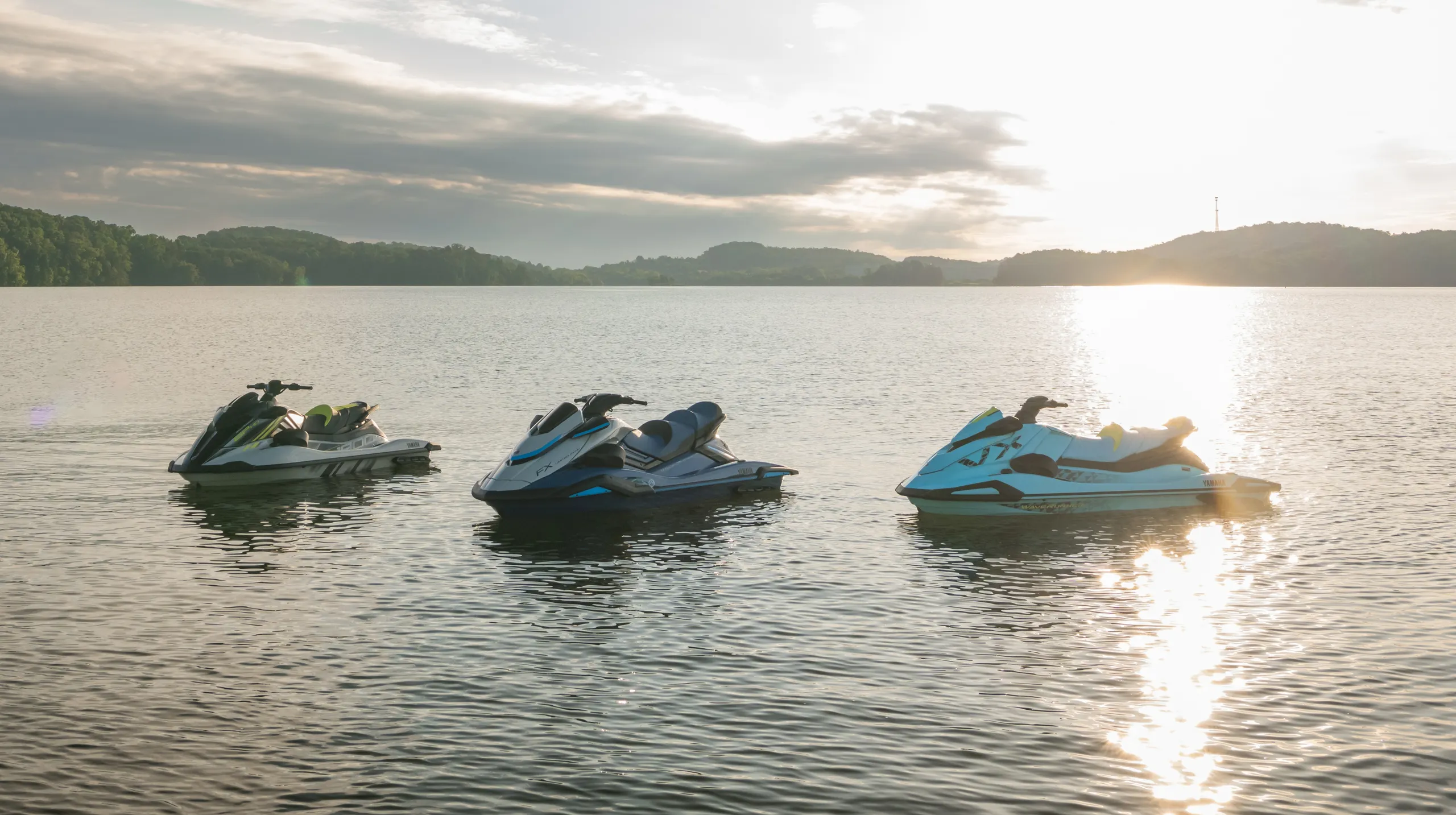 3 Waverunners on water sunset
